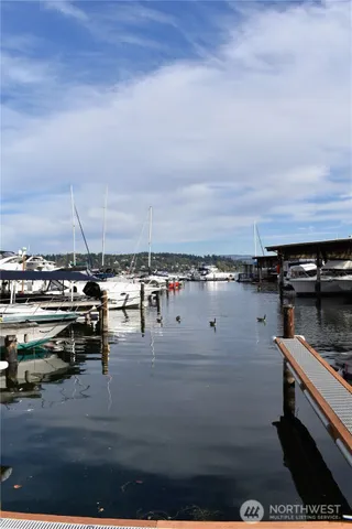 a view of roof deck with dining table and chairs with wooden floor