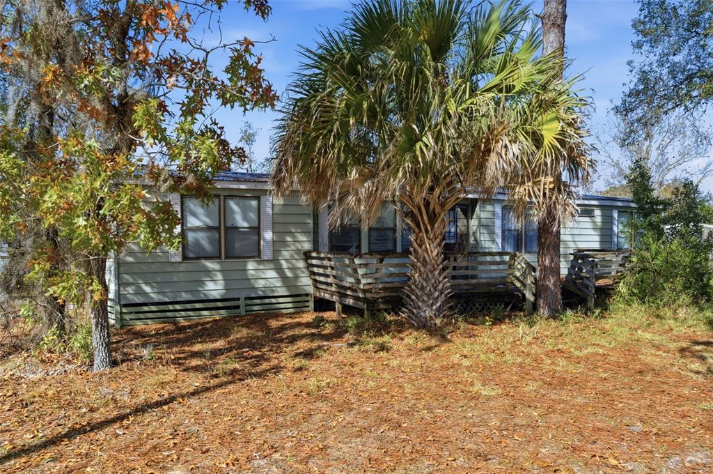8045 Indian Trail Road Weeki Wachee, FL 34613 - Photo 35 of 49 a view of a house with a yard