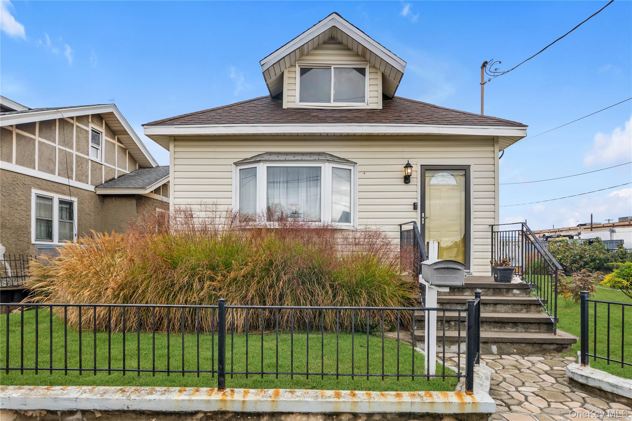 10 3rd Street Queens, NY 11422 - Photo 1 of 1 View of front of home featuring a fenced front yard and roof with shingles