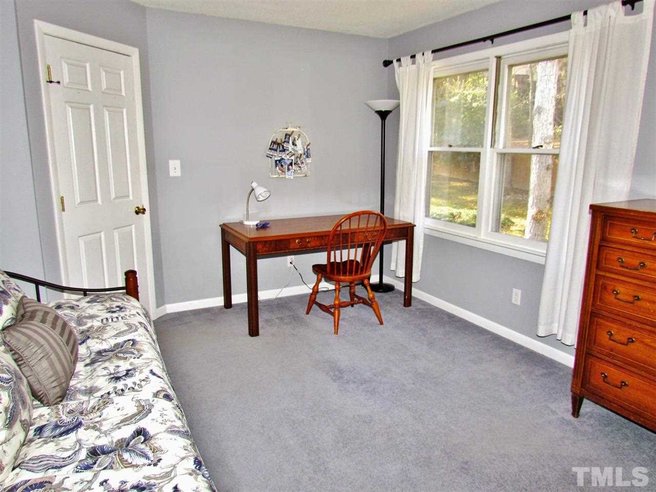 5109 Carter Street Raleigh, NC 27612 - Photo 22 of 25 a bedroom with a bed and a window