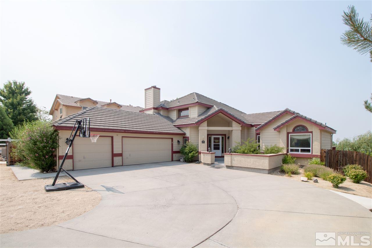 13335 Rim Rock Drive Reno, NV 89521 - Photo 1 of 25 a front view of a house with a yard