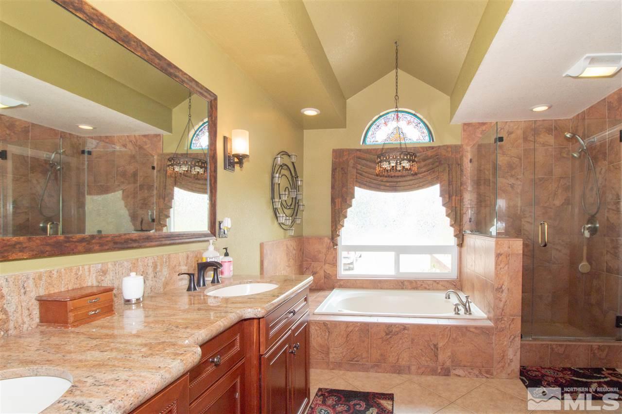 13335 Rim Rock Drive Reno, NV 89521 - Photo 12 of 25 a bathroom with a granite countertop tub sink and mirror