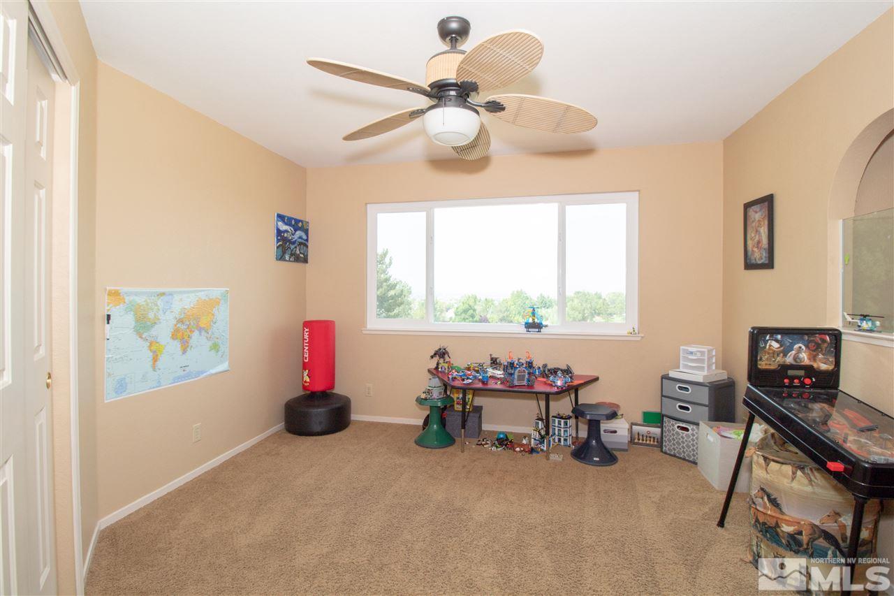 13335 Rim Rock Drive Reno, NV 89521 - Photo 13 of 25 a bedroom with furniture and a window