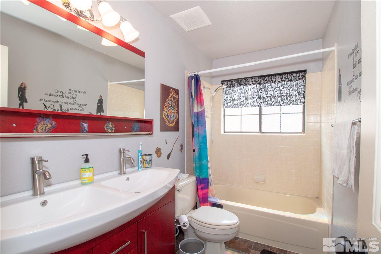 13335 Rim Rock Drive Reno, NV 89521 - Photo 14 of 25 a bathroom with a sink toilet and shower