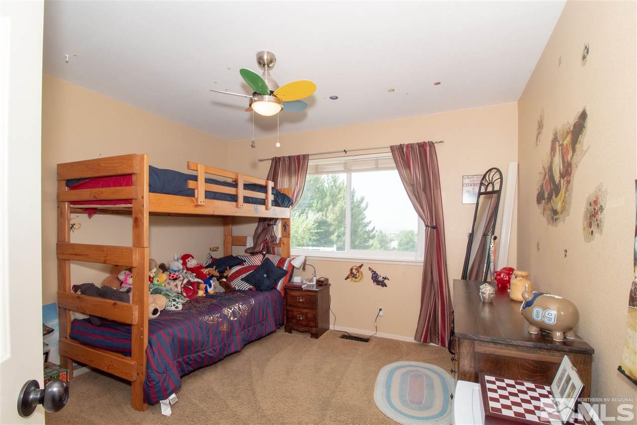 13335 Rim Rock Drive Reno, NV 89521 - Photo 15 of 25 a bed room with a bed and a window