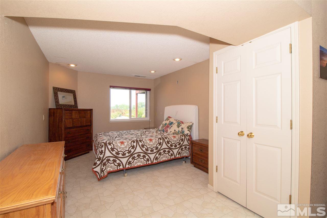 13335 Rim Rock Drive Reno, NV 89521 - Photo 20 of 25 a bedroom with a bed and a window