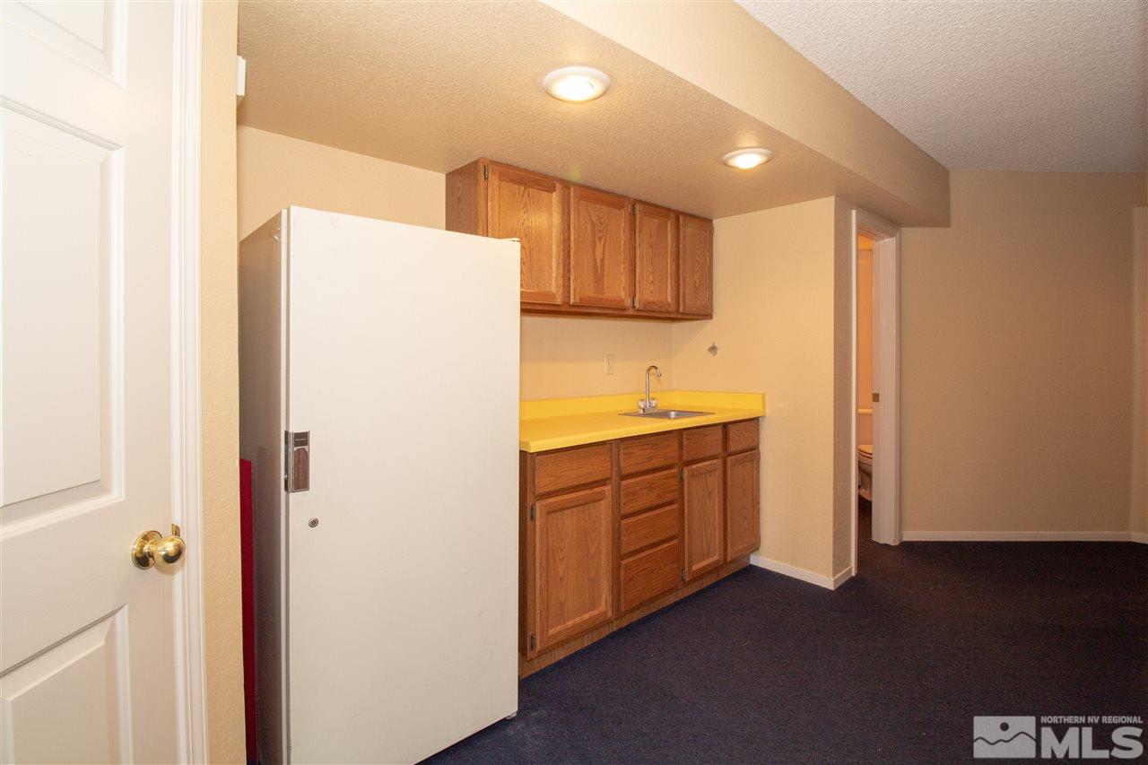 13335 Rim Rock Drive Reno, NV 89521 - Photo 21 of 25 a kitchen with a refrigerator sink and cabinets