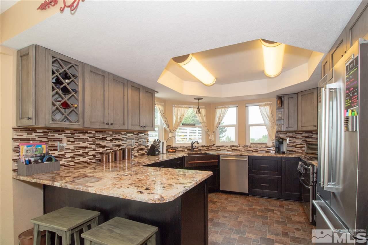 13335 Rim Rock Drive Reno, NV 89521 - Photo 5 of 25 a kitchen with a sink and a refrigerator