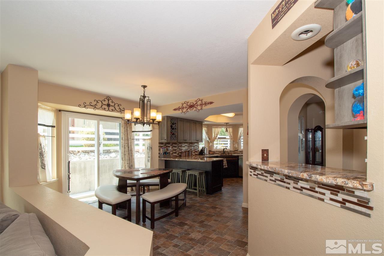 13335 Rim Rock Drive Reno, NV 89521 - Photo 6 of 25 a living room with fireplace furniture and a large window