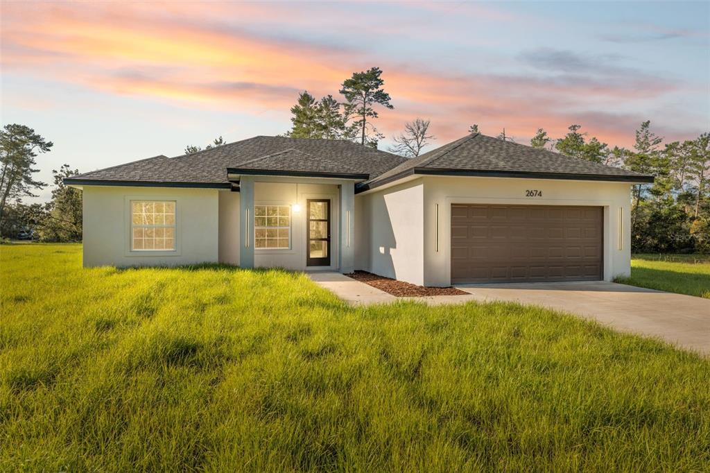2674 Southwest 173rd Place Road Ocala, FL 34473 - Photo 1 of 1 a front view of a house with yard