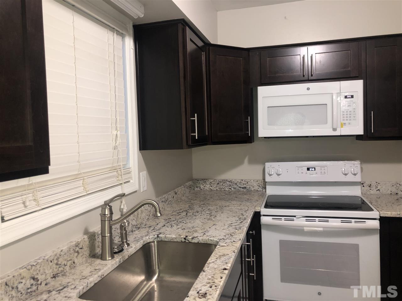 4244 Lake Ridge Drive, Unit 12B Raleigh, NC 27604 - Photo 17 of 28 a kitchen with a stove and a microwave