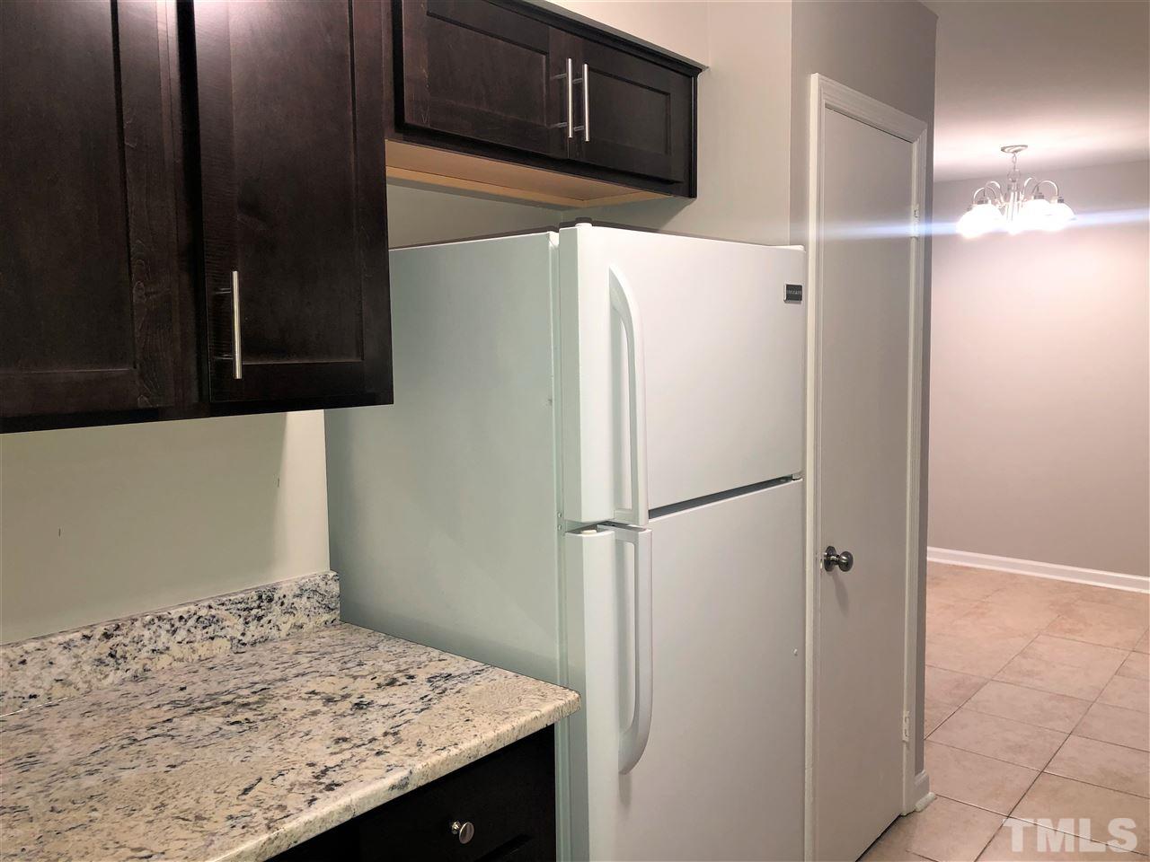 4244 Lake Ridge Drive, Unit 12B Raleigh, NC 27604 - Photo 18 of 28 a white refrigerator freezer sitting in a kitchen