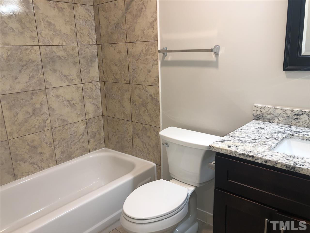 4244 Lake Ridge Drive, Unit 12B Raleigh, NC 27604 - Photo 5 of 28 a bathroom with a granite countertop toilet sink and bathtub