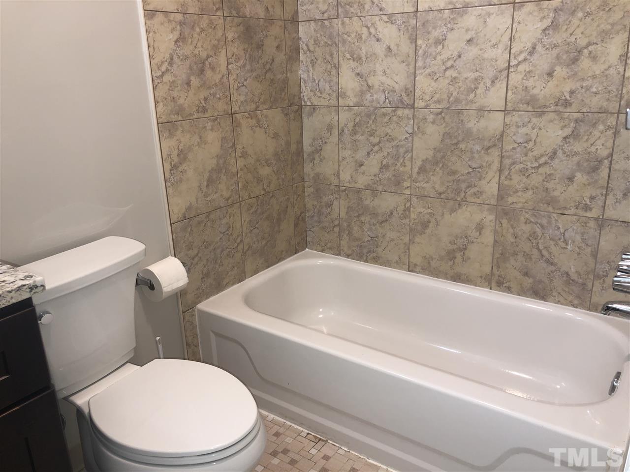 4244 Lake Ridge Drive, Unit 12B Raleigh, NC 27604 - Photo 9 of 28 a white toilet sitting next to a bath tub