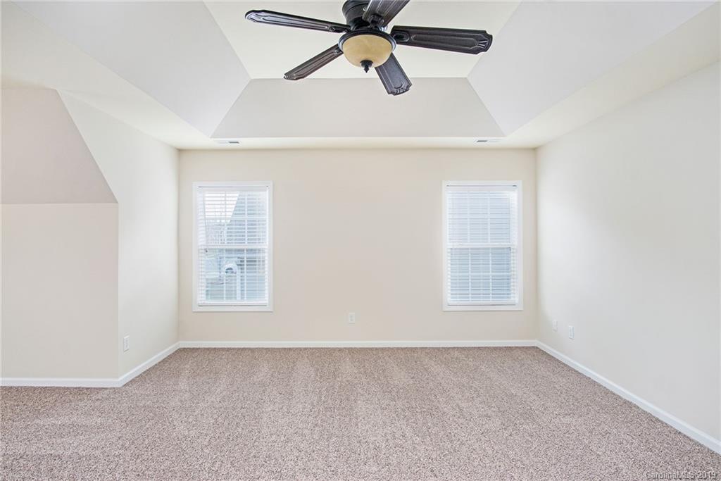 3727 Burnage Hall Road Harrisburg, NC 28075 - Photo 13 of 21 an empty room with windows and fan