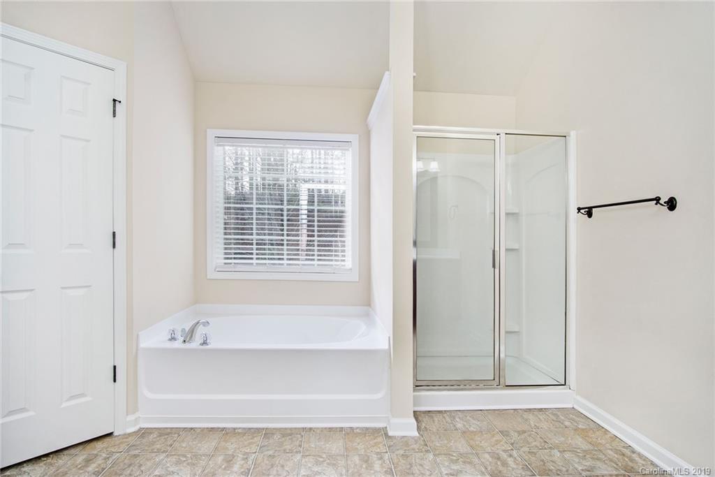 3727 Burnage Hall Road Harrisburg, NC 28075 - Photo 15 of 21 a bathroom with a bathtub and shower