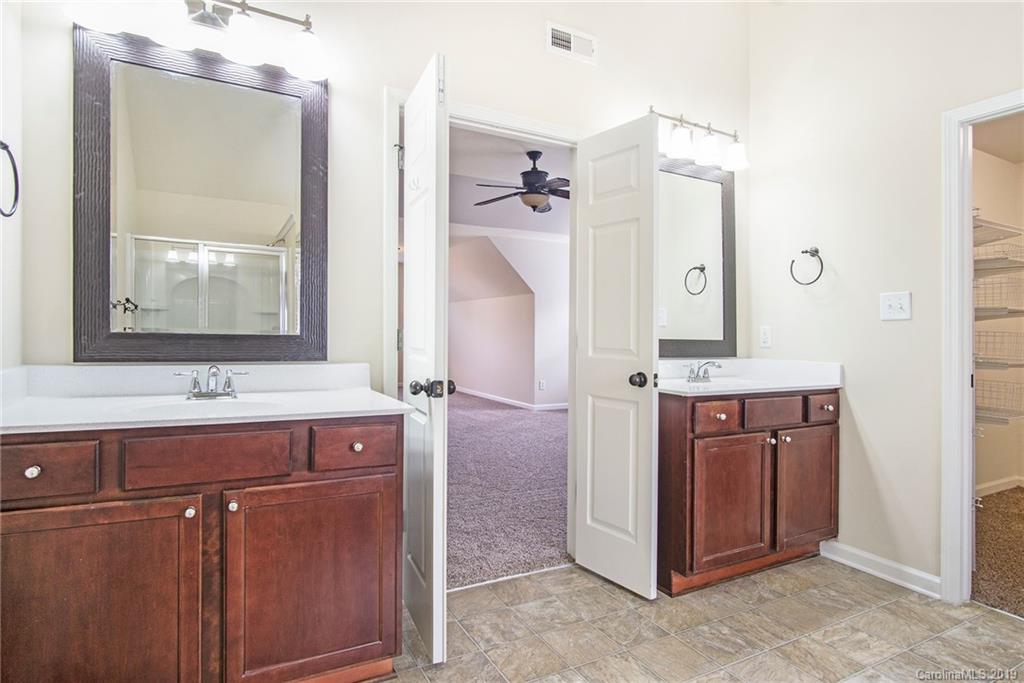 3727 Burnage Hall Road Harrisburg, NC 28075 - Photo 16 of 21 a bathroom with a double vanity sink mirror and double