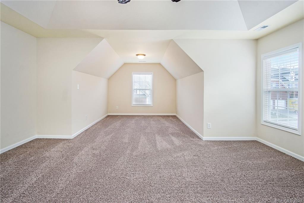 3727 Burnage Hall Road Harrisburg, NC 28075 - Photo 4 of 21 an empty room with windows and closet