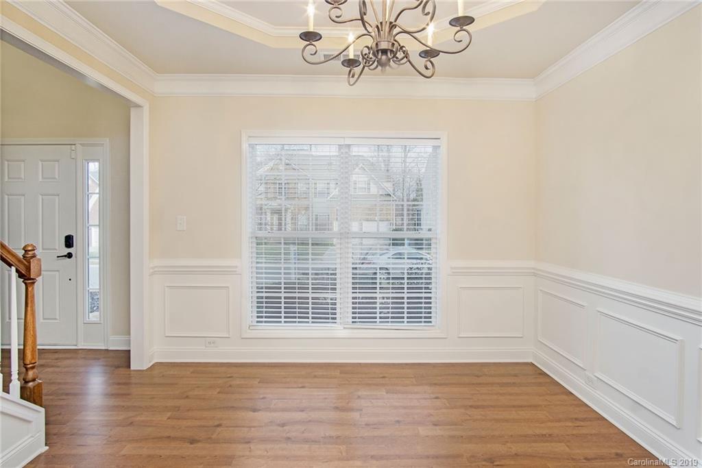 3727 Burnage Hall Road Harrisburg, NC 28075 - Photo 6 of 21 a view of an empty room with wooden floor and a window