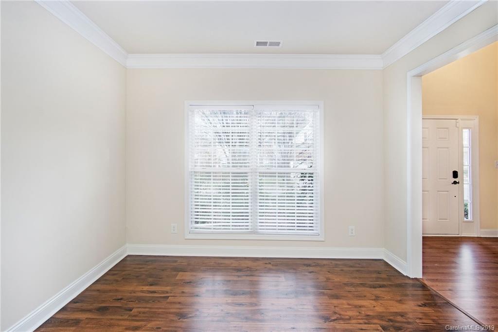 3727 Burnage Hall Road Harrisburg, NC 28075 - Photo 7 of 21 an empty room with wooden floor and windows