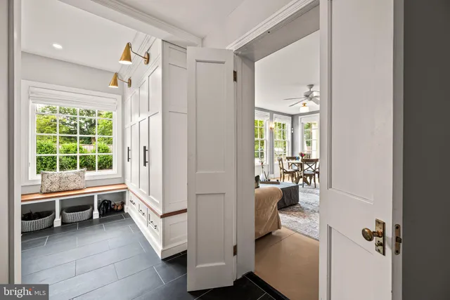 a view of entryway with workspace and livingroom view