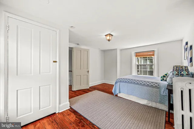 a living room with a bed and a window