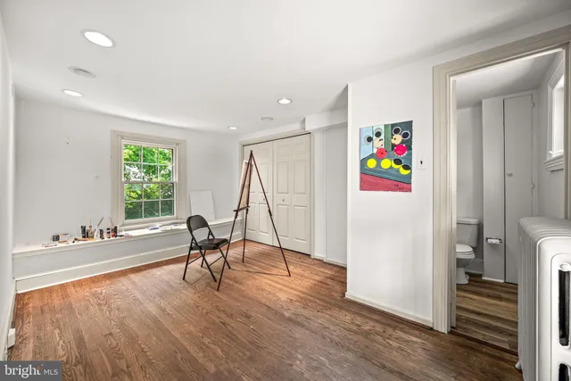 a sitting room with furniture and a wooden floor