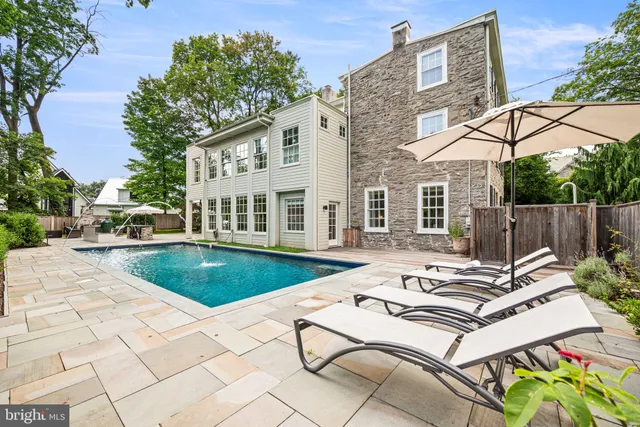 a view of a patio with chairs and potted plants