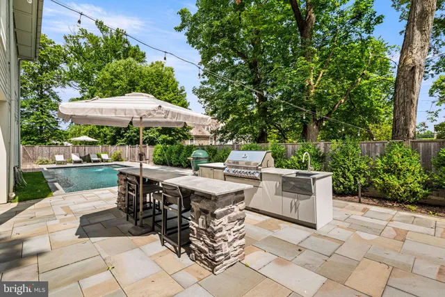 a view of backyard with outdoor seating and trees