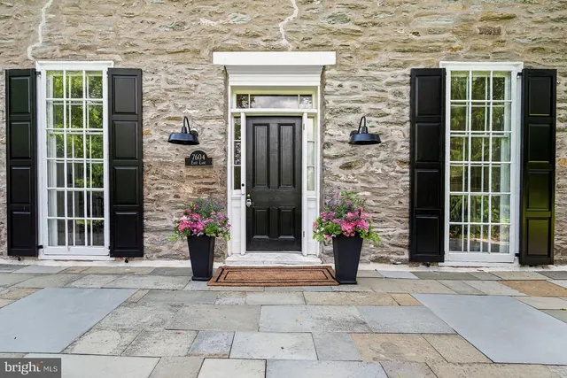 a view of a house with potted plants