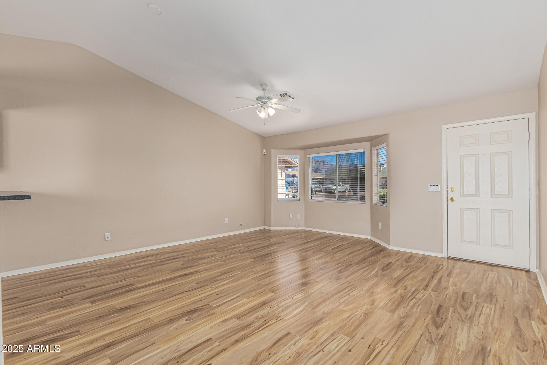 2264 South Belair Road Apache Junction, AZ 85119 - Photo 5 of 19 wooden floor in an empty room with a window