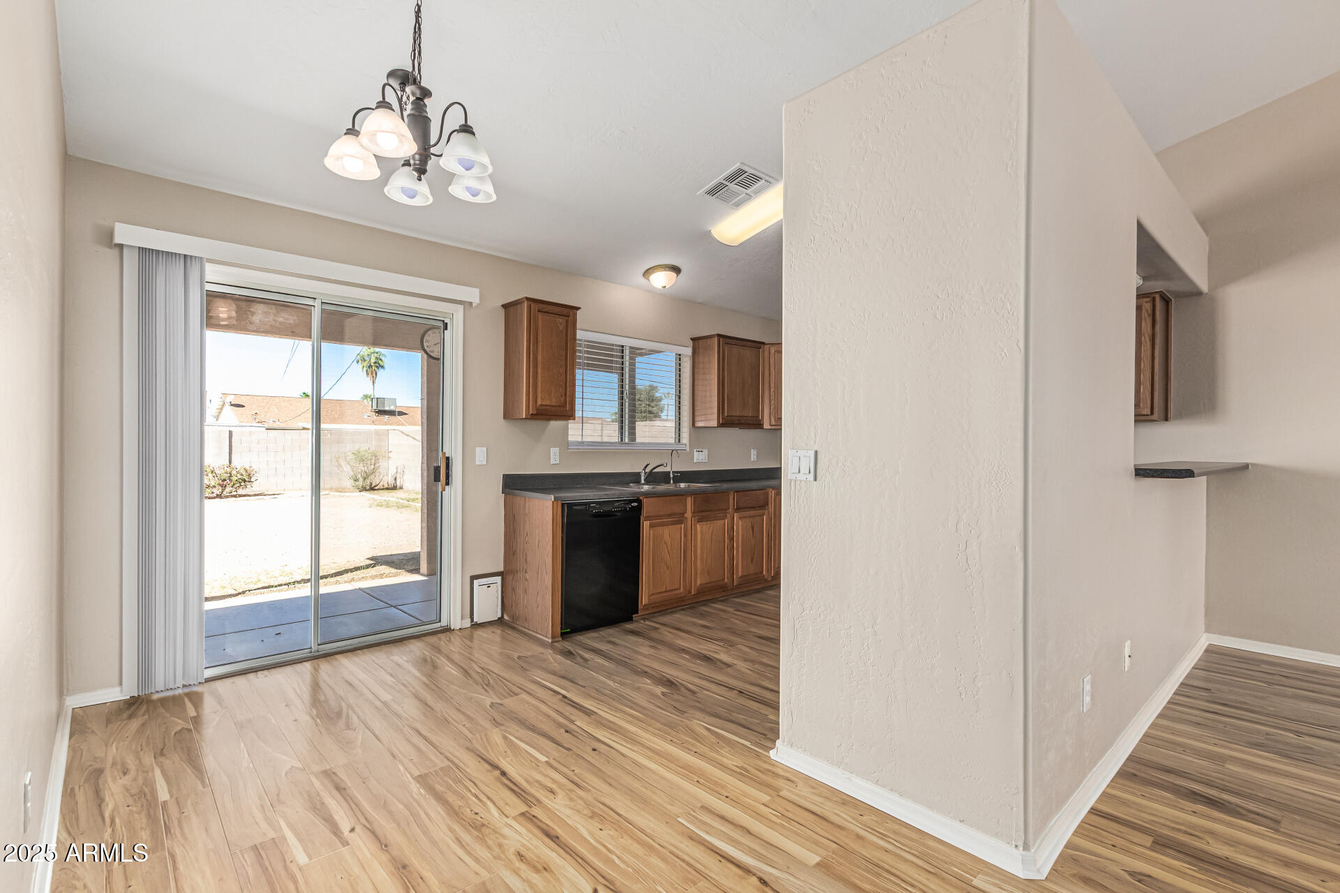 2264 South Belair Road Apache Junction, AZ 85119 - Photo 6 of 19 a view of a kitchen with a sink and dishwasher with wooden floor