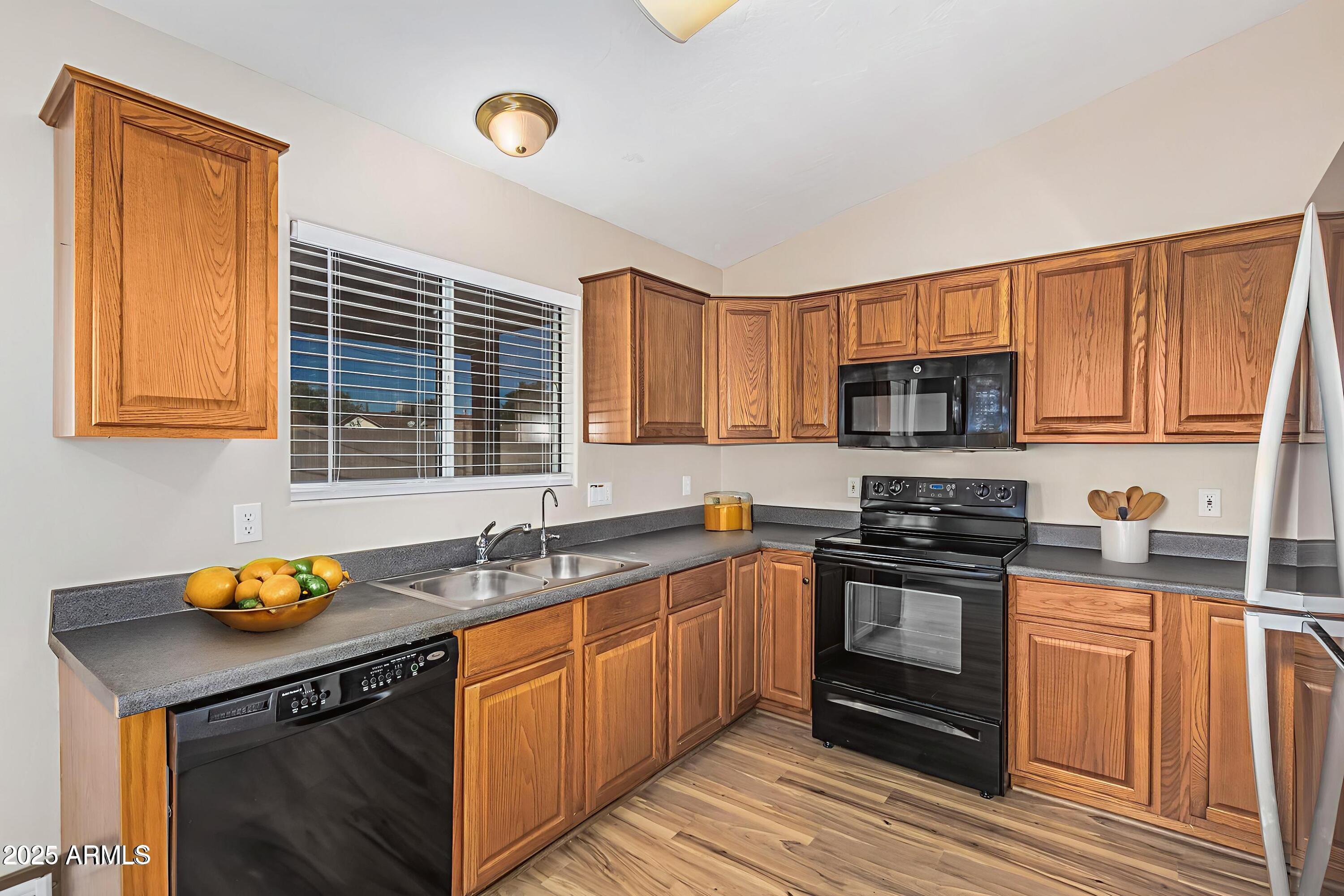 2264 South Belair Road Apache Junction, AZ 85119 - Photo 7 of 19 a kitchen with stainless steel appliances granite countertop a sink stove and cabinets