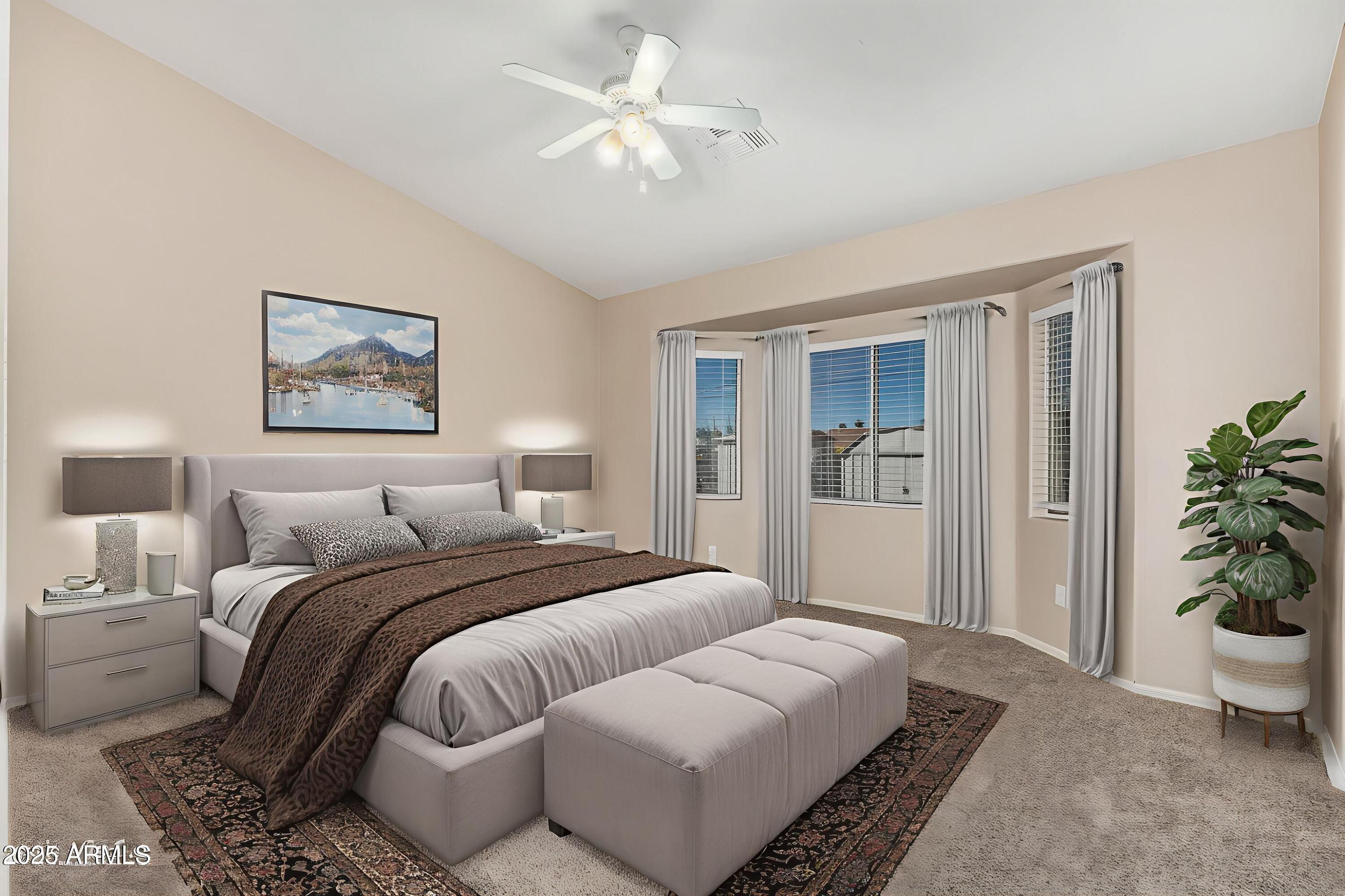 2264 South Belair Road Apache Junction, AZ 85119 - Photo 9 of 19 a bedroom with a large bed and a chandelier