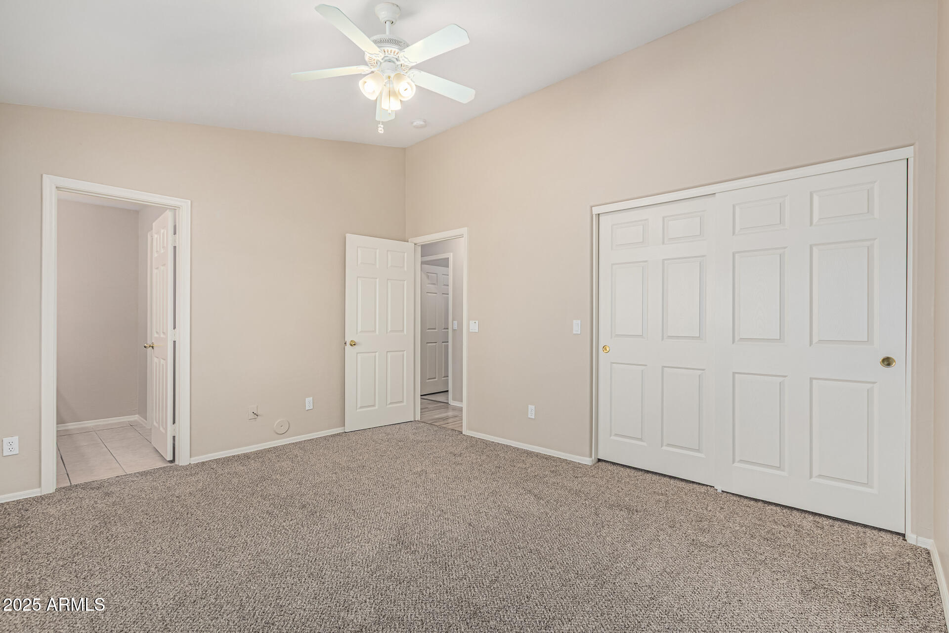 2264 South Belair Road Apache Junction, AZ 85119 - Photo 10 of 19 an empty room with a ceiling fan and a window