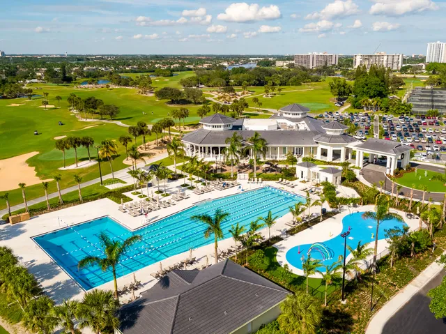 a patio with water view and palm trees