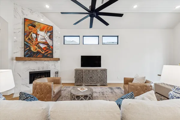 a living room with fireplace furniture and a flat screen tv