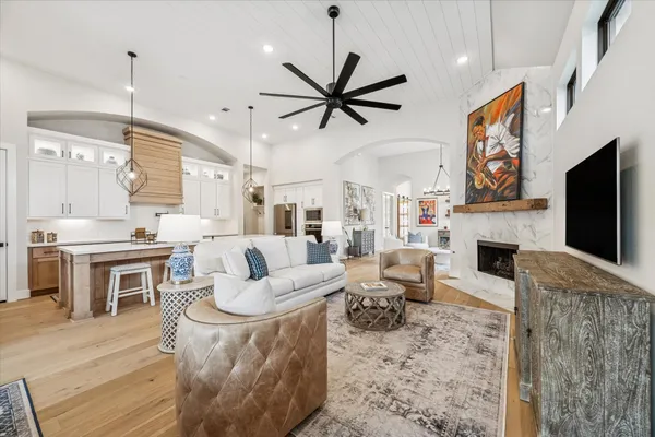 a large kitchen with kitchen island a sink a stove a dining table and chairs