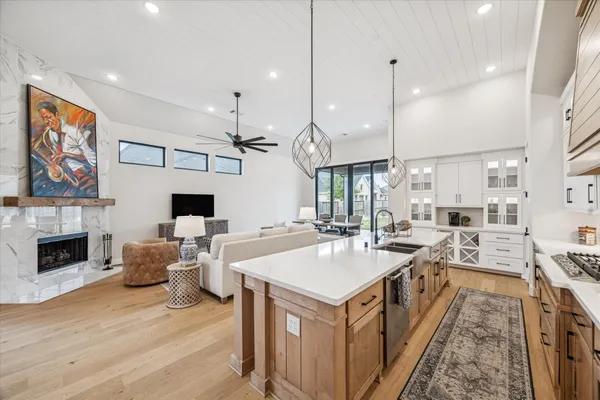 a living room with furniture a ceiling fan and a flat screen tv
