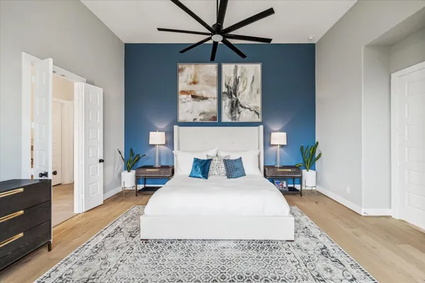 a bedroom with a bed a large window and a flat screen tv