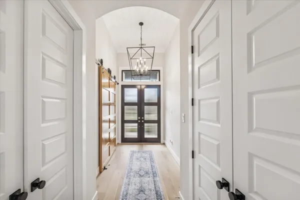 wooden floor with white walls and windows