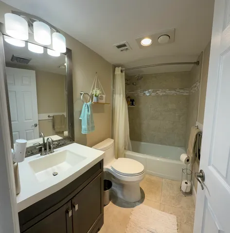 a bathroom with a sink toilet a mirror and shower