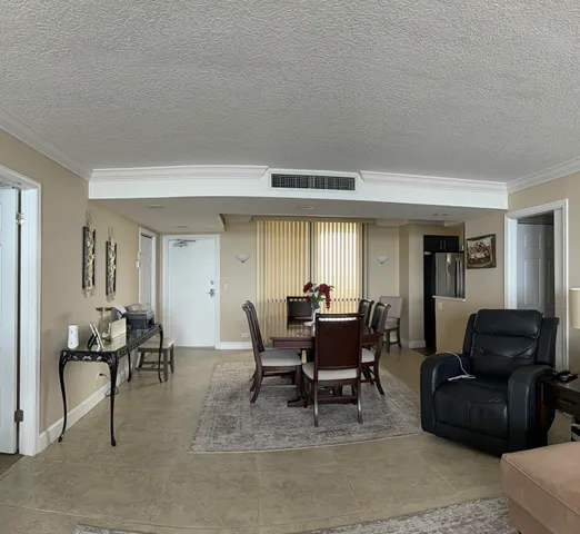a living room with furniture and a dining table