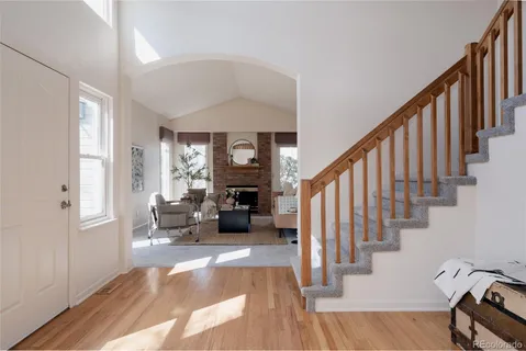 a view of entryway livingroom and hall with wooden floor