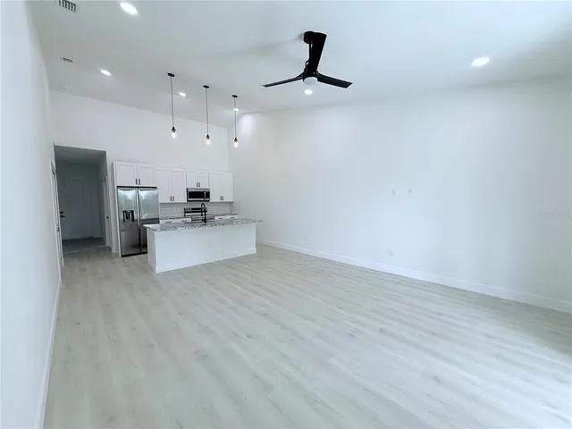 a living room with furniture and kitchen view