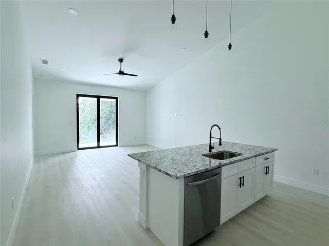 a kitchen with a sink stove and cabinets