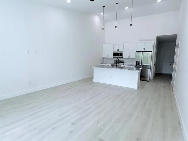a kitchen with stainless steel appliances a refrigerator and a stove top oven