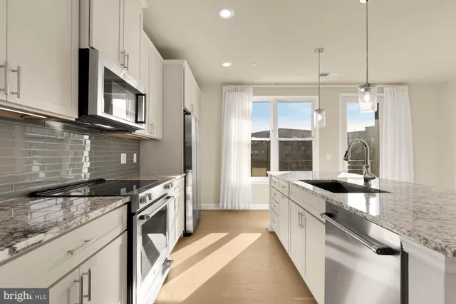 a kitchen with granite countertop a sink and a stove