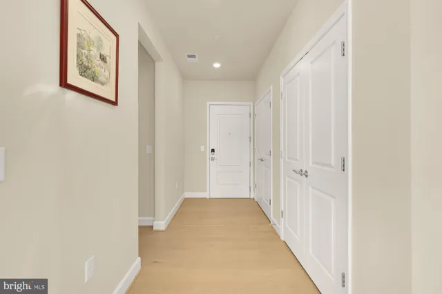 a view of a hallway with white walls