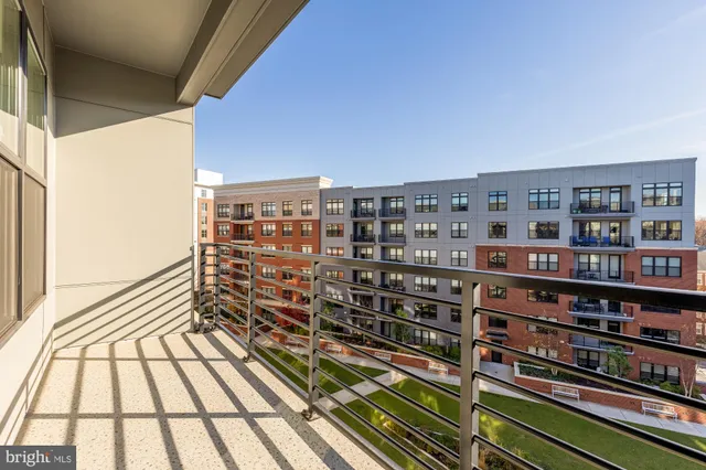 a view of a balcony with wooden floor and city view